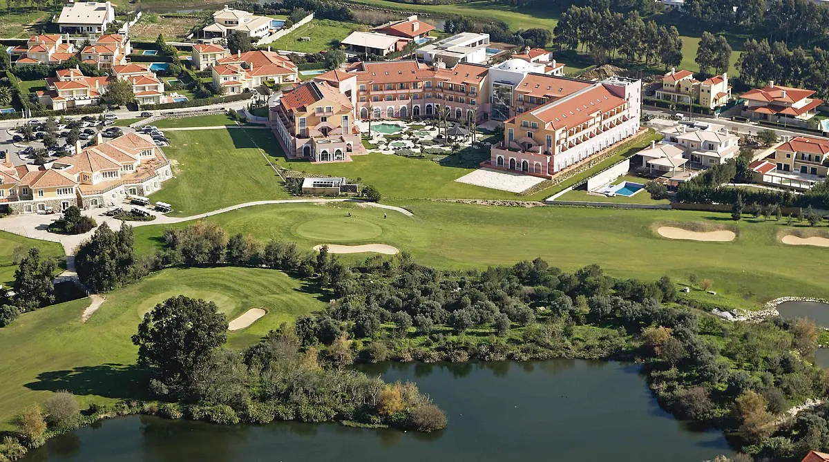 Aerial view of Quinta da Beloura: the Pestana Sintra Golf hotel, the greens and a tree-lined lake